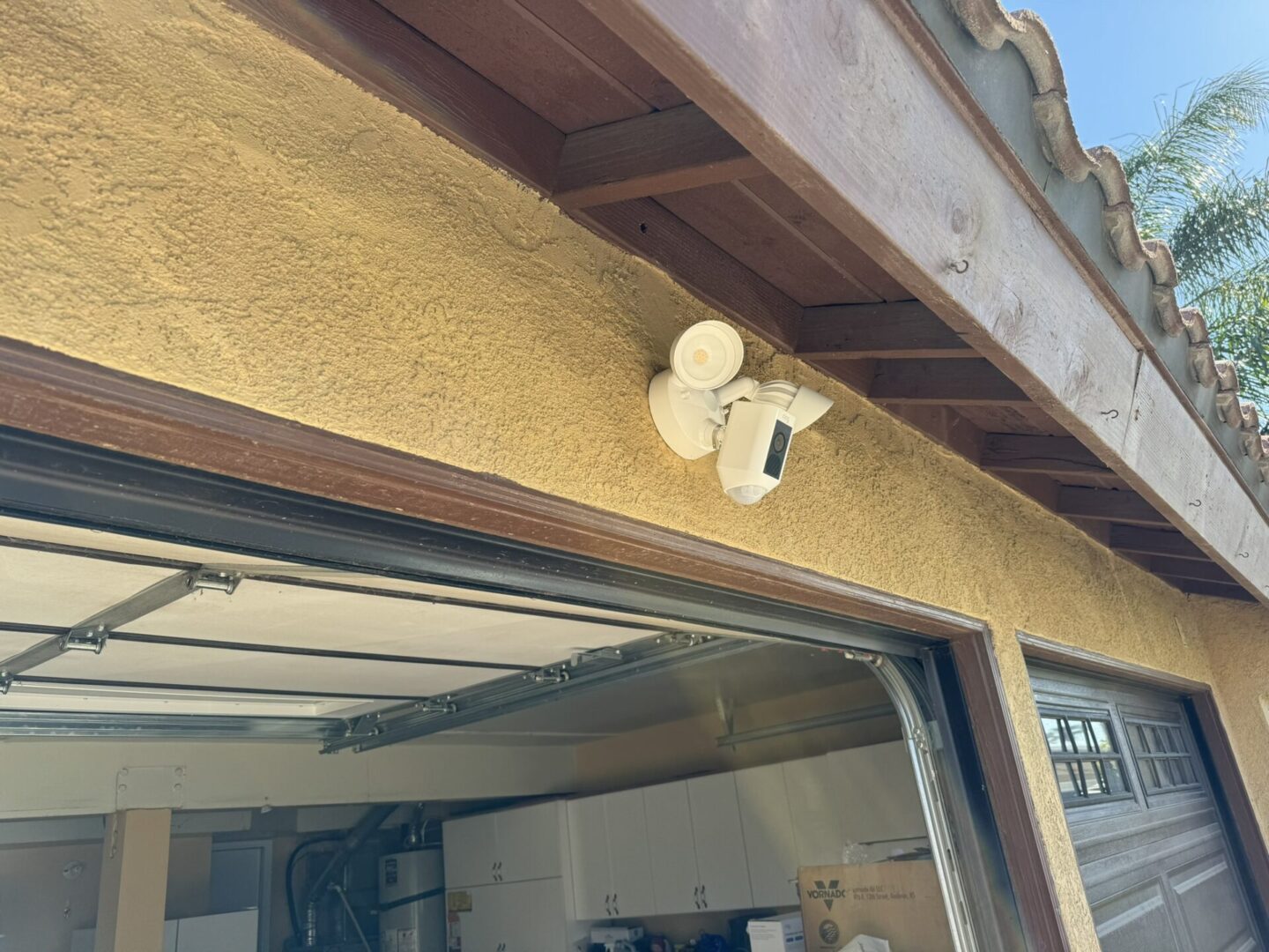 A camera mounted to the side of a building.