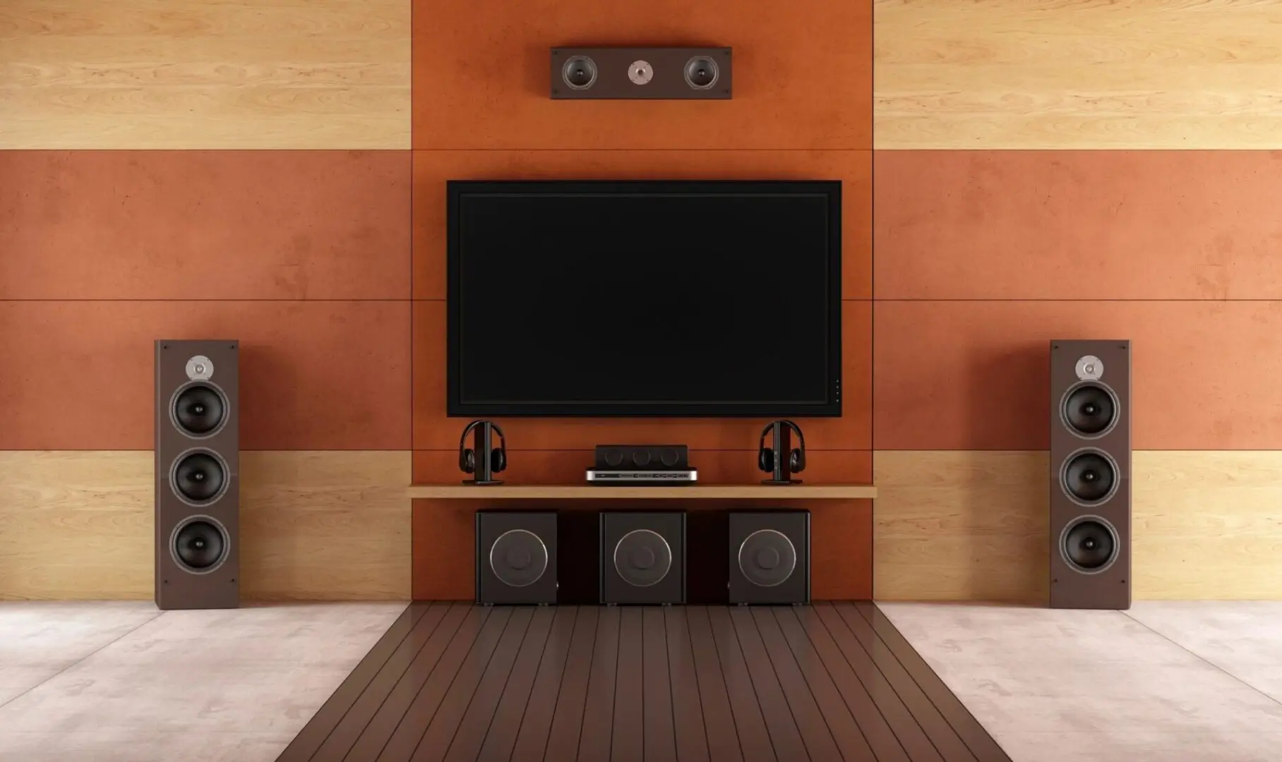 A modern home entertainment system featuring a wall-mounted flat-screen TV, two standing speakers, three subwoofers, and headphones on a shelf, all integrated into a wood panel wall for seamless Smart Home Solutions.